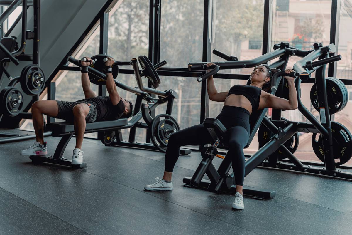 Man using L-carnitine supplement to build muscle during weight training