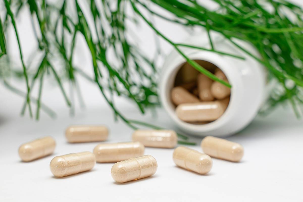 l carnitine for fat loss supplement bottle next to running shoes and water bottle